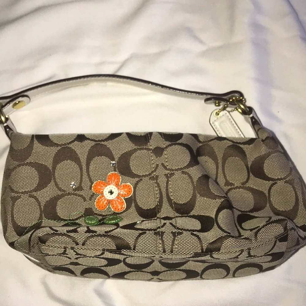 Small tan couch purse with orange flower appliqué